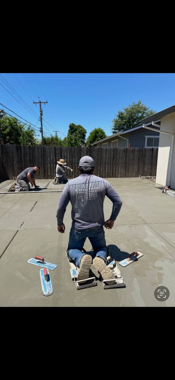A.M. Concrete crew finishing a freshly poured concrete slab in Sacramento